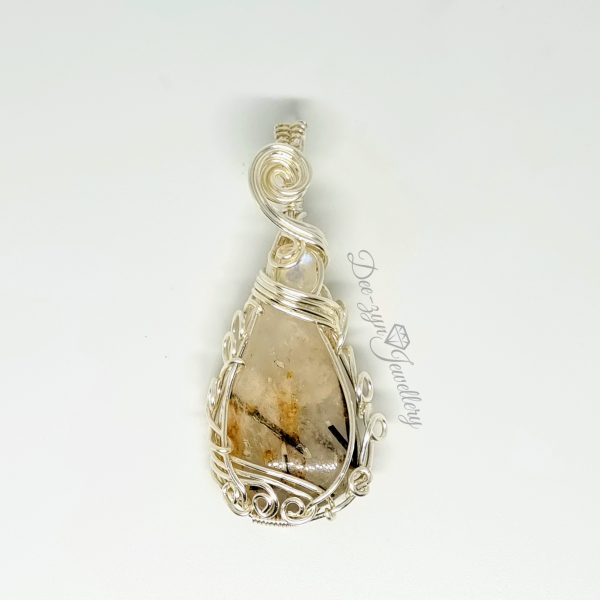 Rutilated Quartz and Rainbow Moonstone Captured in a Silver Filled Wire Sculptured Pendant on white background. Front view
