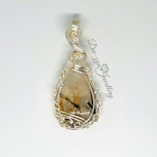 Rutilated Quartz and Rainbow Moonstone Captured in a Silver Filled Wire Sculptured Pendant on white background.