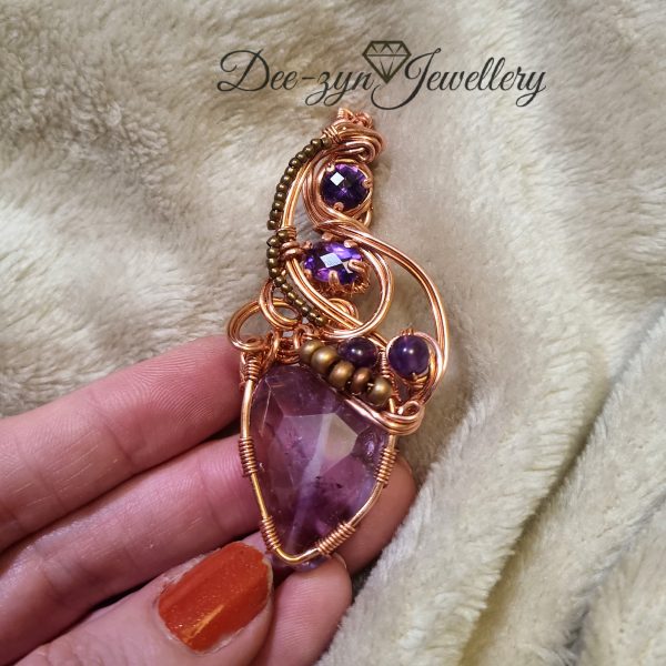 Front view of Amethyst pendant being held for sizing